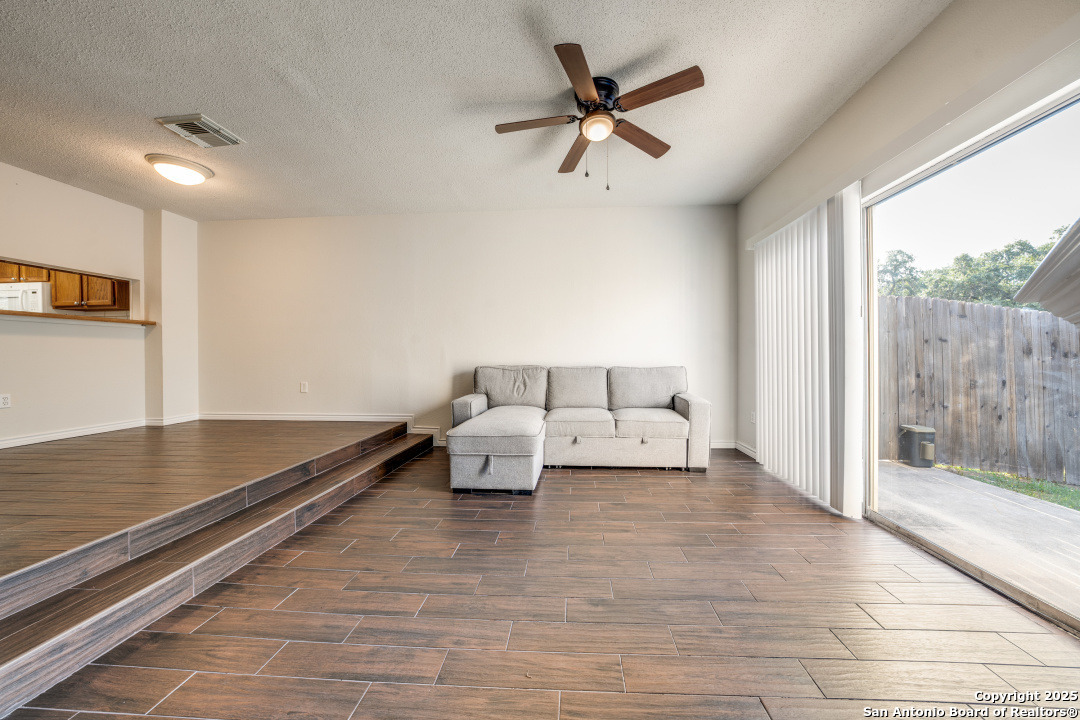 10254 Dover Ridge, Unit 204 San Antonio, TX 78250 - Photo 8 of 31 a living room with furniture and a floor to ceiling window