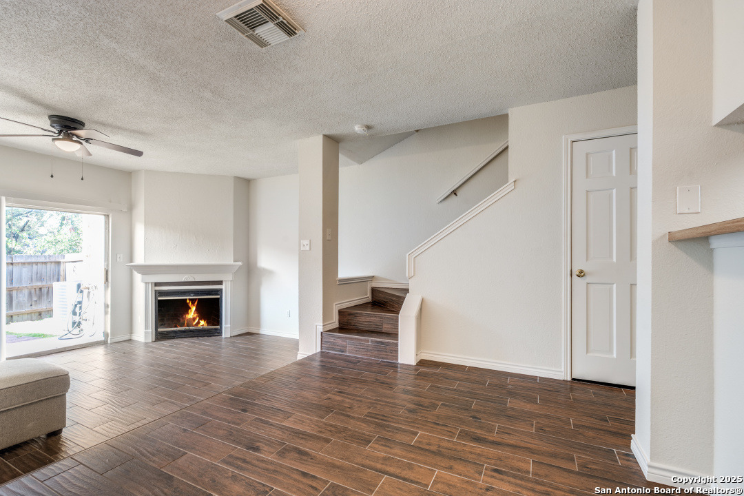 10254 Dover Ridge, Unit 204 San Antonio, TX 78250 - Photo 9 of 31 a view of a livingroom with a fireplace wooden floor and window