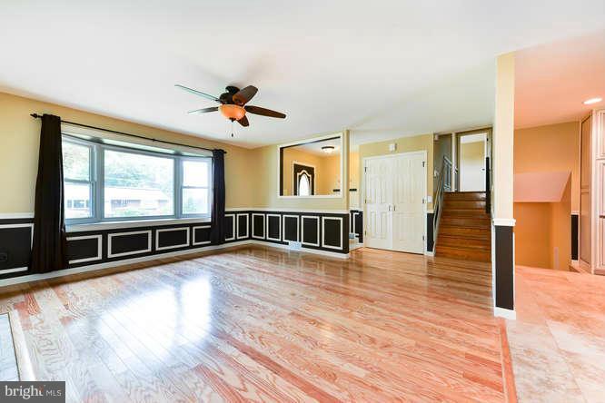 5918 Atteentee Road Springfield, VA 22150 - Photo 4 of 25 an empty room with wooden floor and windows
