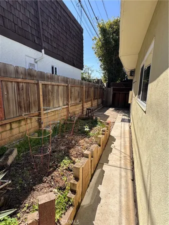 a view of a backyard with wooden fence