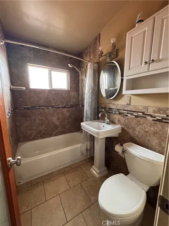 a bathroom with a sink toilet and mirror
