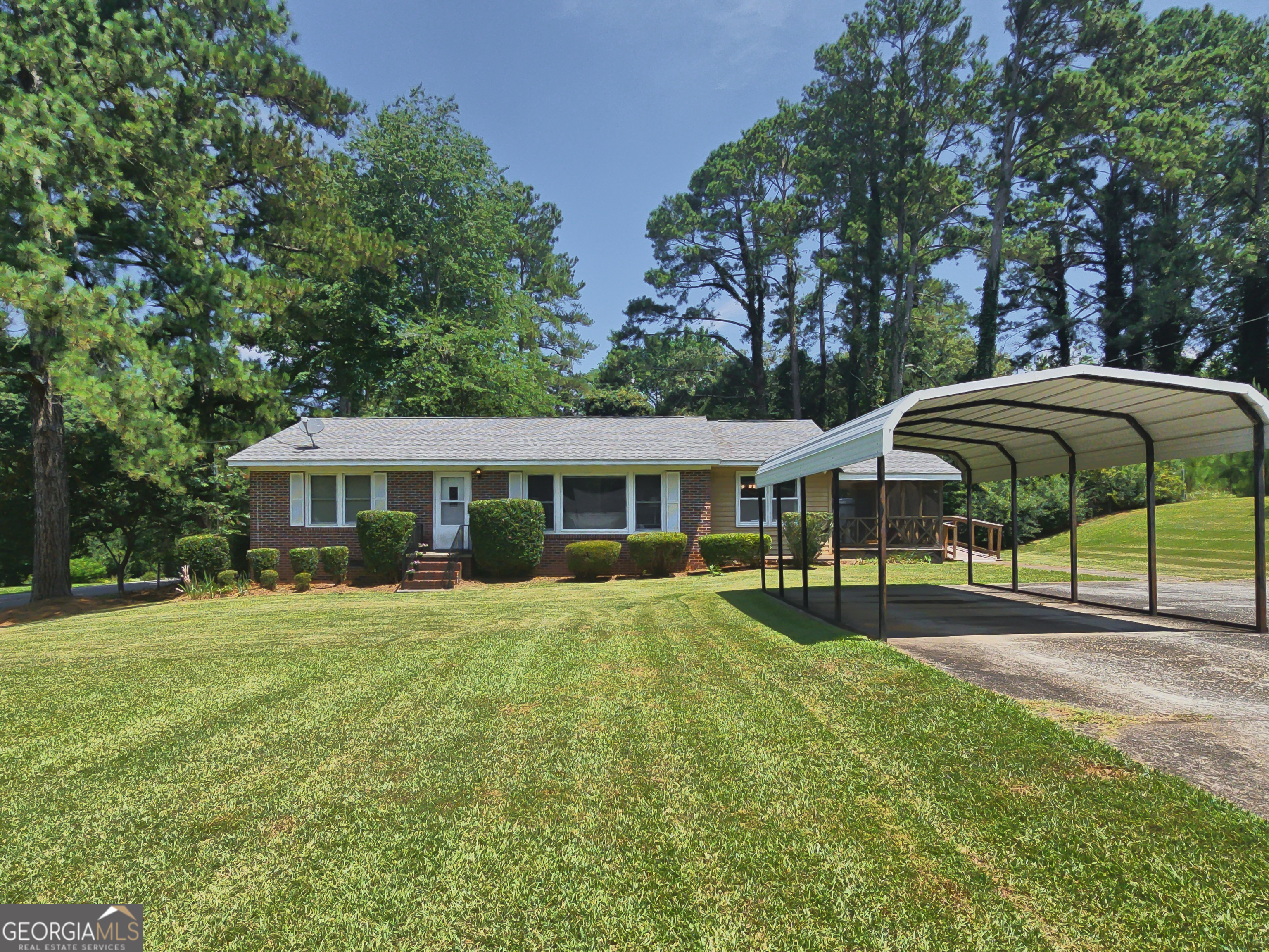 a view of a house with a yard and sitting area