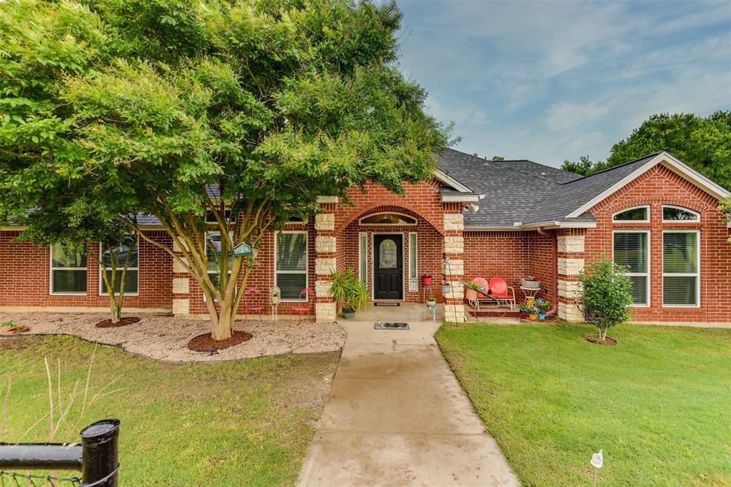 a front view of a house with a yard table and chairs