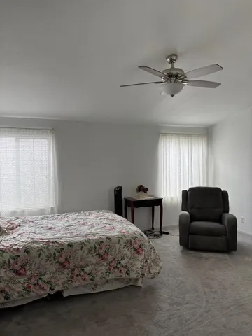 a bedroom with a bed couch and a window
