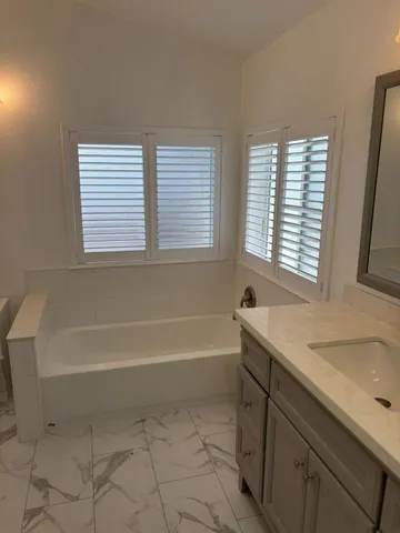 a bathroom with a bathtub and a sink