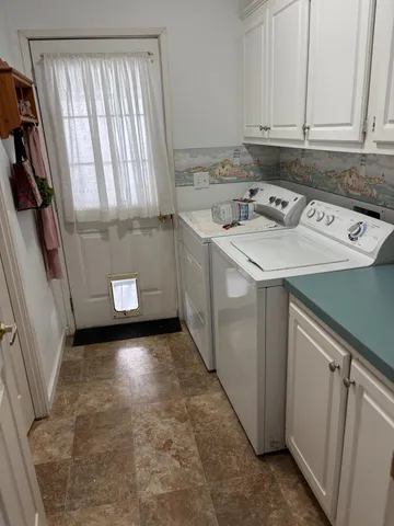 a utility room with window washer and dryer
