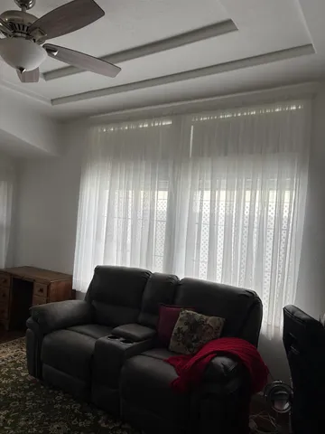 a living room with furniture and a large window