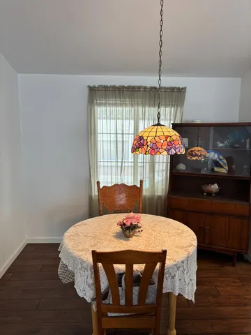 a kitchen that has a table and a fireplace in it