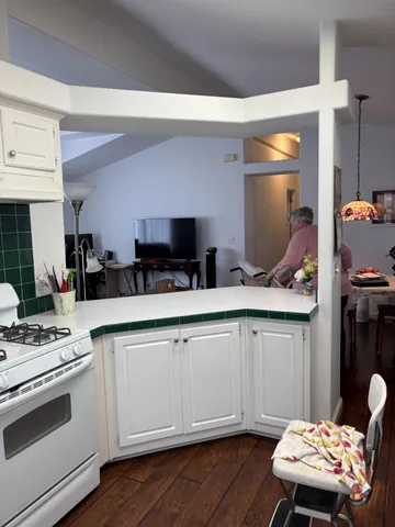 a kitchen with a sink appliances and cabinets
