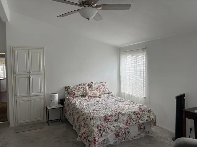 a bedroom with a bed and a window