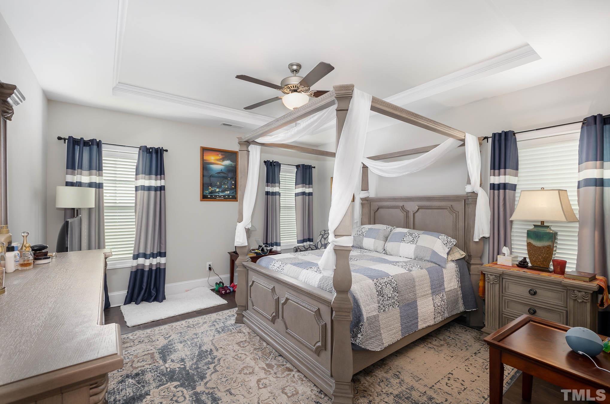 8801 Rainer Way Wake Forest, NC 27587 - Photo 13 of 34 a bedroom with a bed and a couch