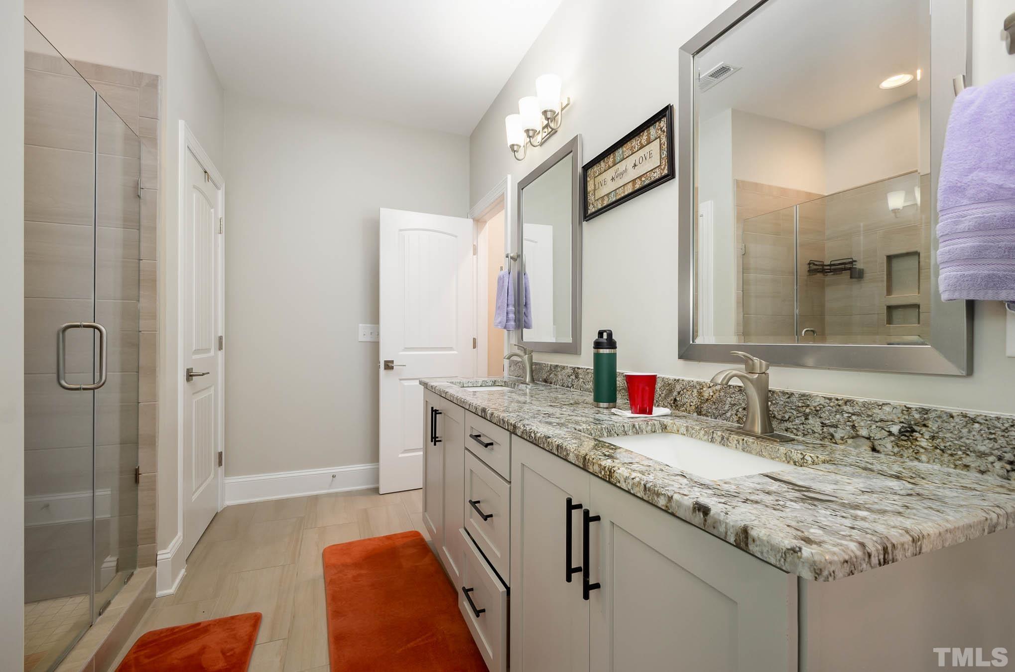 8801 Rainer Way Wake Forest, NC 27587 - Photo 14 of 34 a bathroom with a granite countertop sink and a mirror