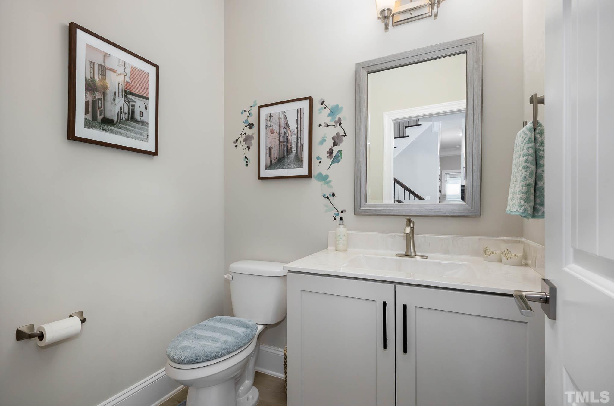 8801 Rainer Way Wake Forest, NC 27587 - Photo 16 of 34 a bathroom with a toilet sink and mirror