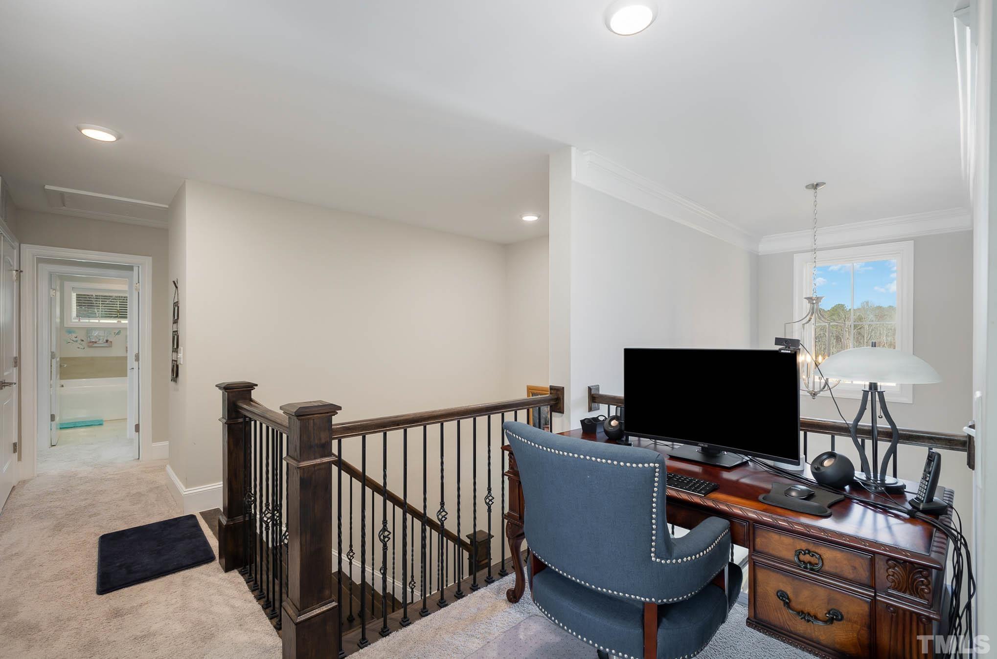 8801 Rainer Way Wake Forest, NC 27587 - Photo 17 of 34 a view of a workspace with furniture and a flat screen tv