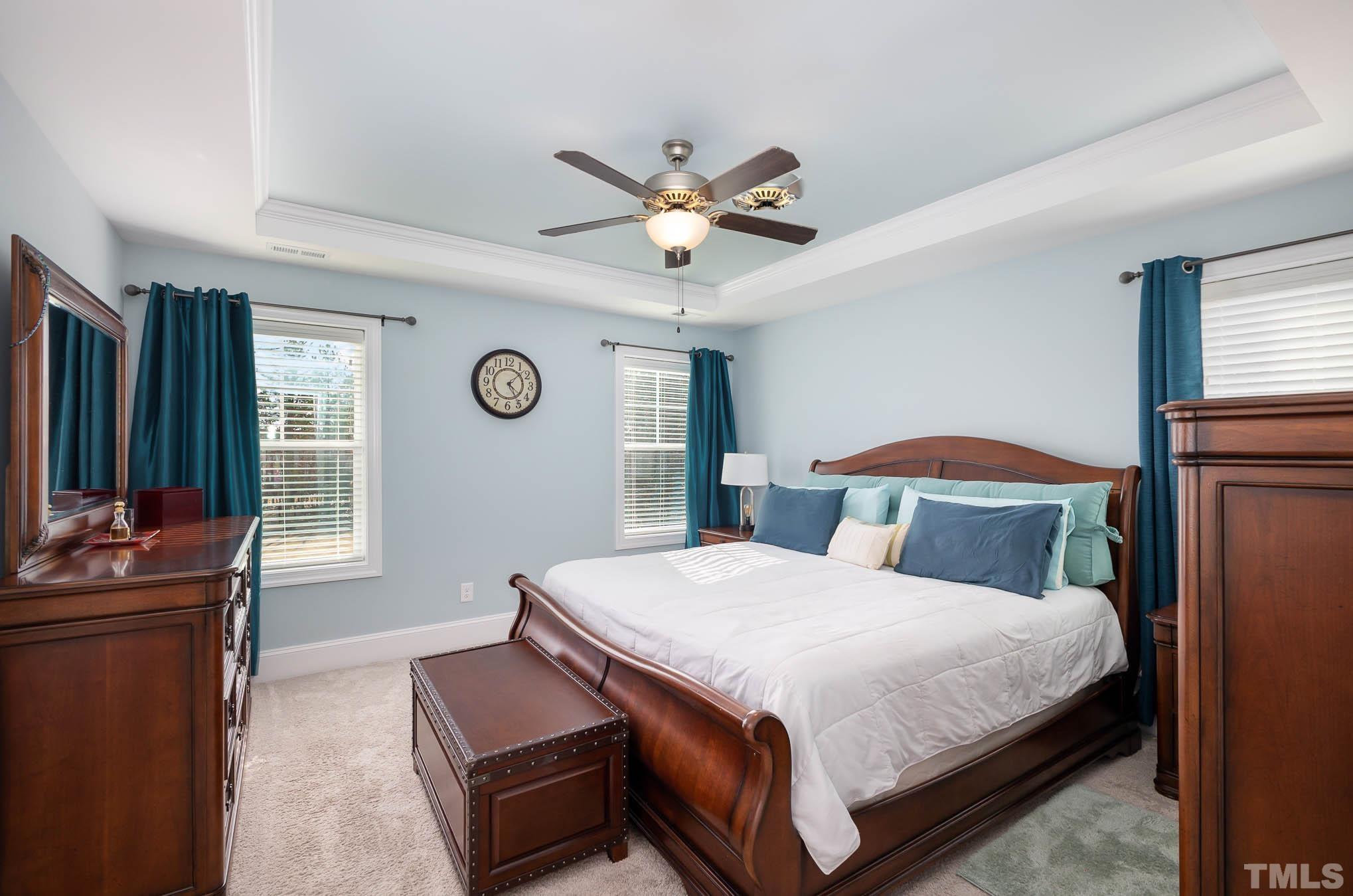 8801 Rainer Way Wake Forest, NC 27587 - Photo 22 of 34 a bedroom with a bed and a chandelier