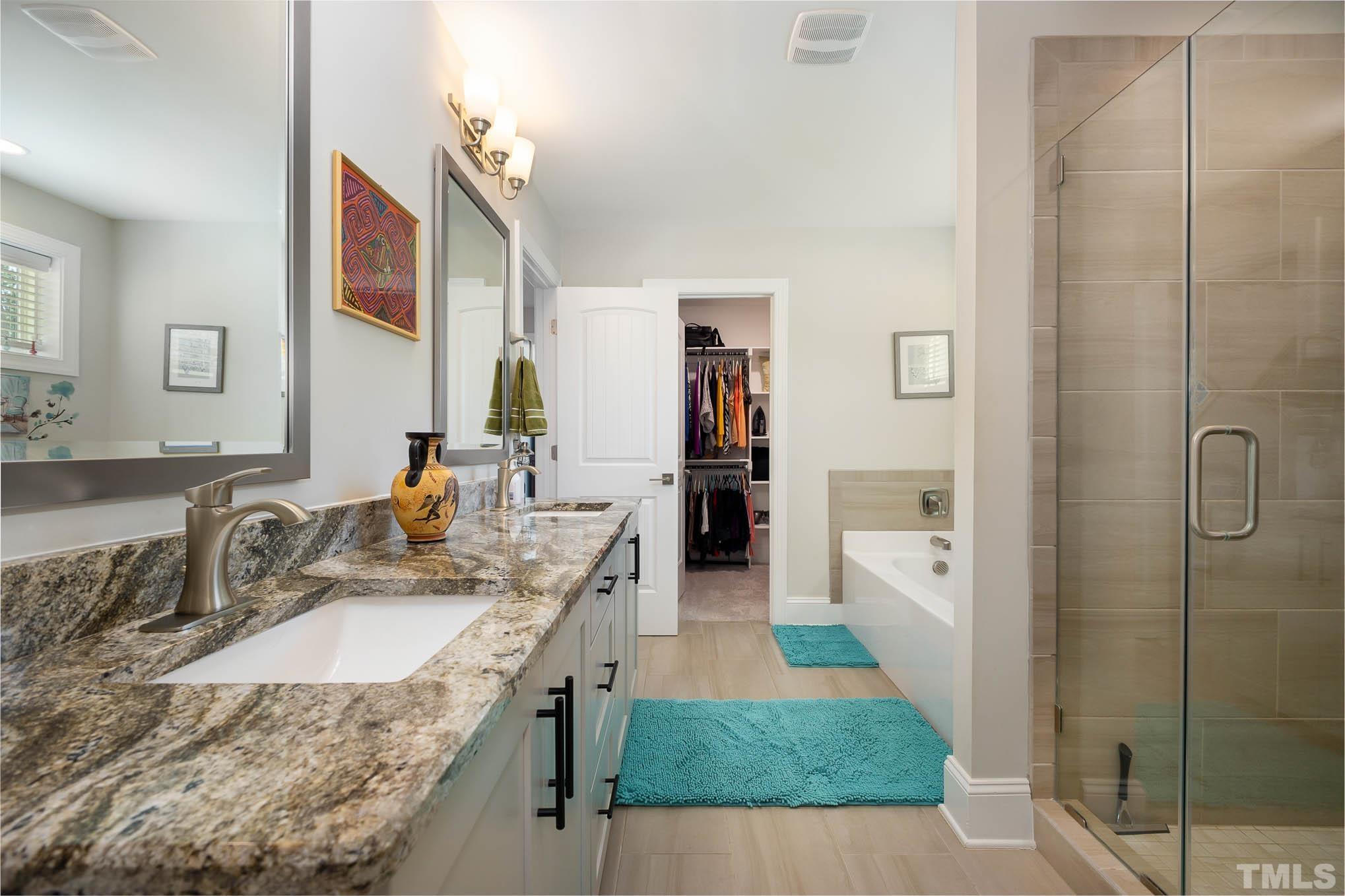 8801 Rainer Way Wake Forest, NC 27587 - Photo 26 of 34 a bathroom with a granite countertop sink a mirror and shower