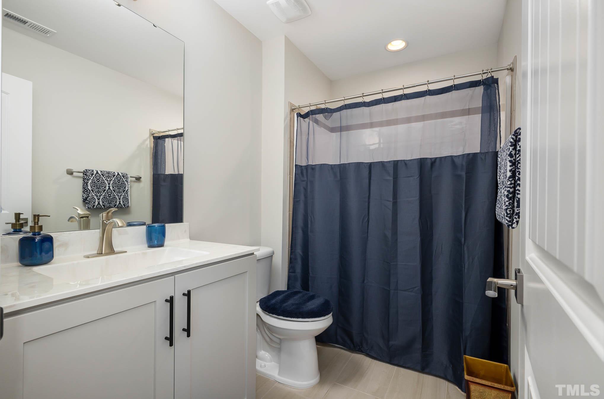 8801 Rainer Way Wake Forest, NC 27587 - Photo 27 of 34 a bathroom with a sink a toilet and shower