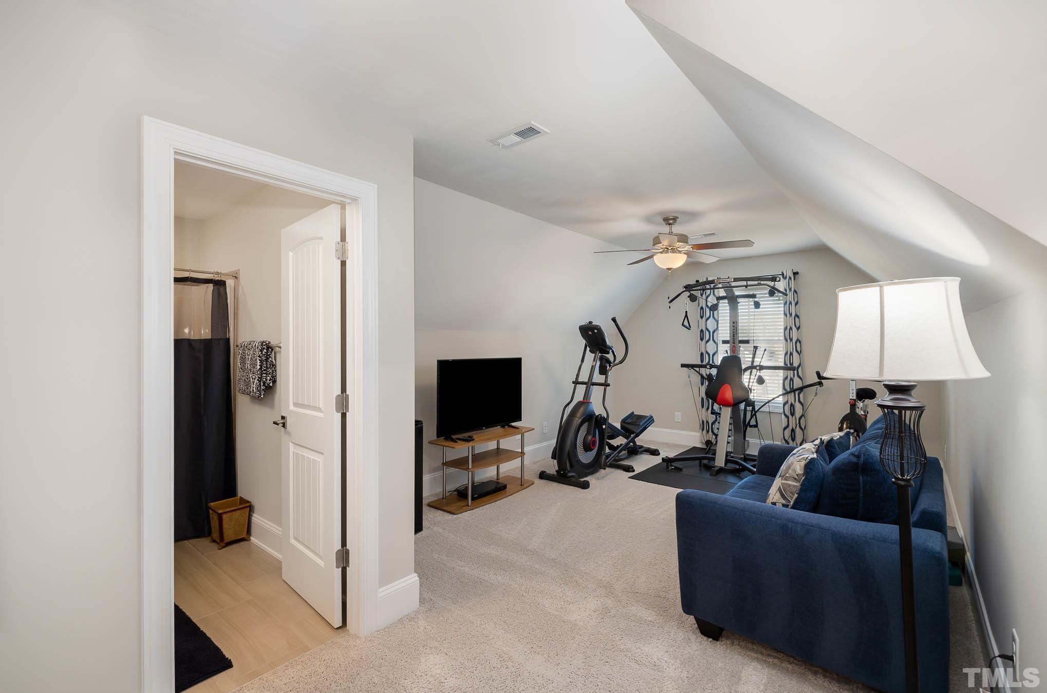 8801 Rainer Way Wake Forest, NC 27587 - Photo 28 of 34 a living room with furniture and a flat screen tv