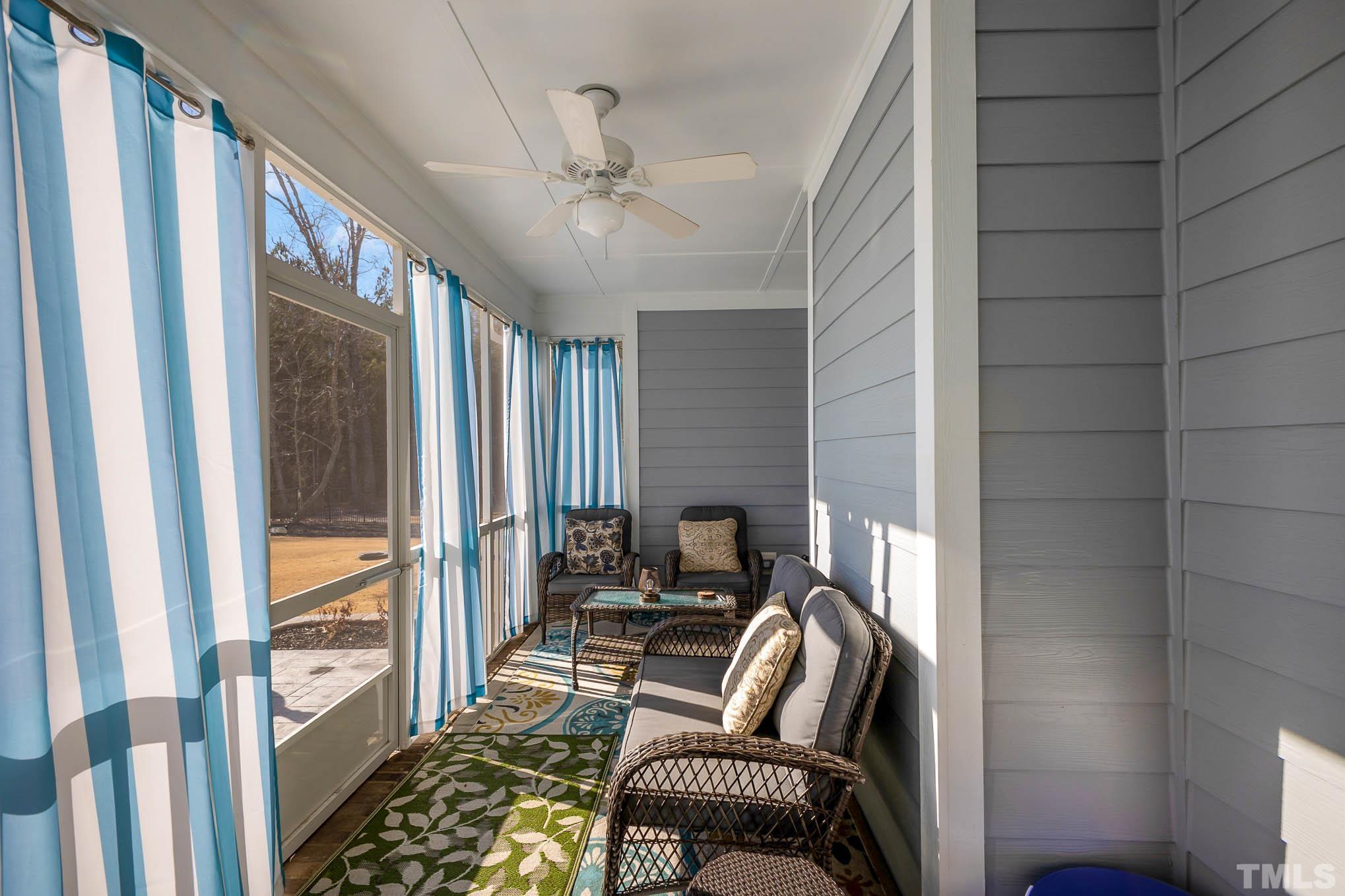 8801 Rainer Way Wake Forest, NC 27587 - Photo 29 of 34 a living room with furniture and a floor to ceiling window