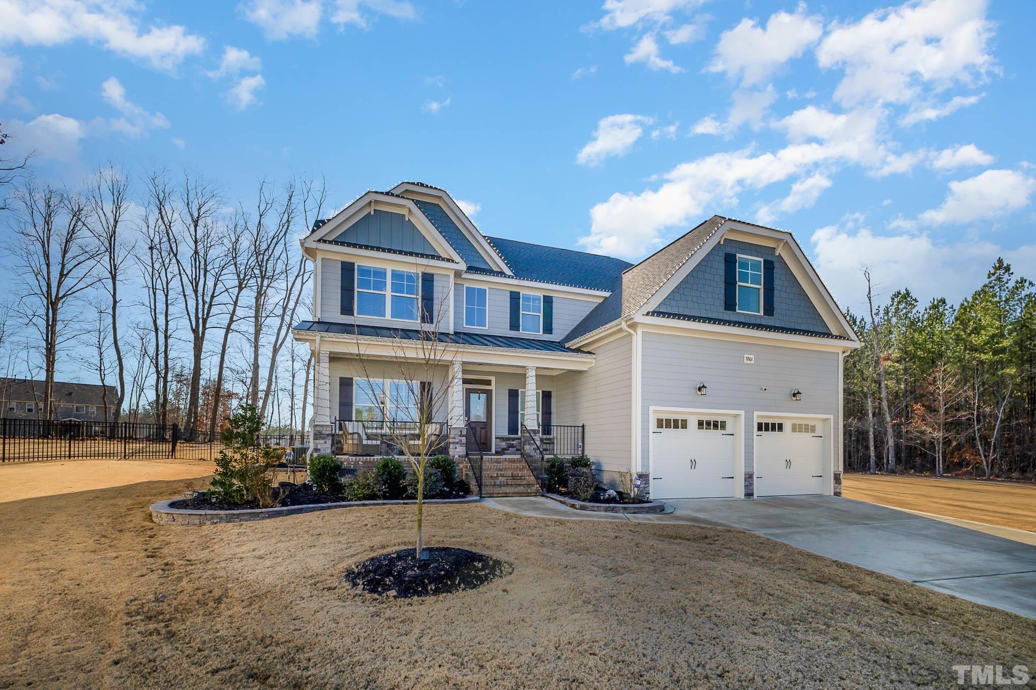 8801 Rainer Way Wake Forest, NC 27587 - Photo 3 of 34 a front view of a house with a yard