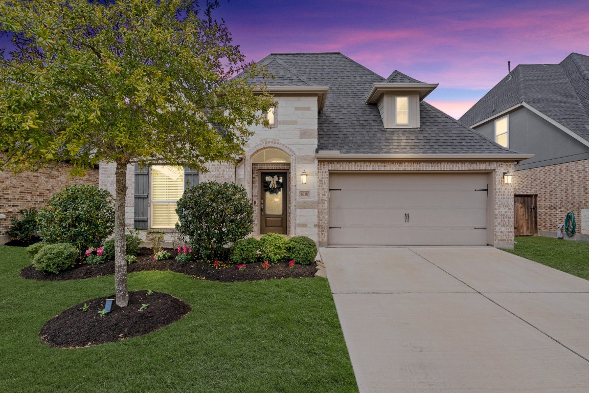 6918 Goldstrum Way Katy, TX 77493 - Photo 1 of 27 a front view of a house with a garden