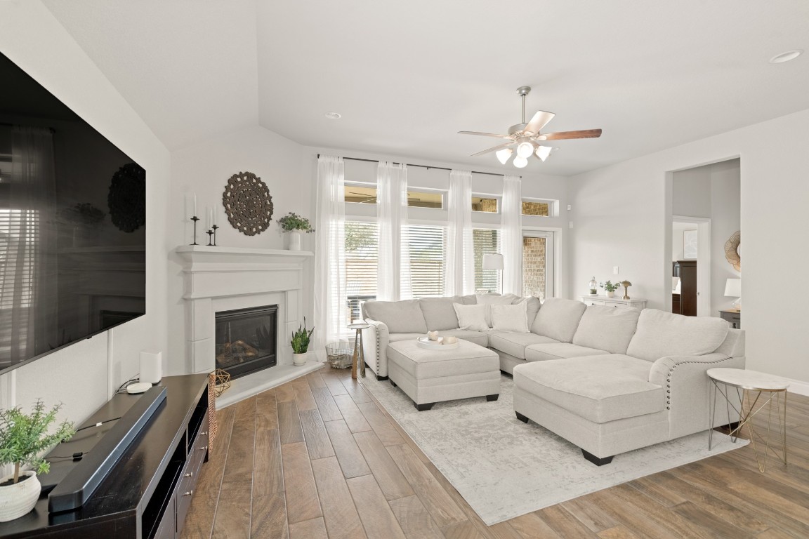 6918 Goldstrum Way Katy, TX 77493 - Photo 11 of 27 a living room with furniture a flat screen tv and a fireplace