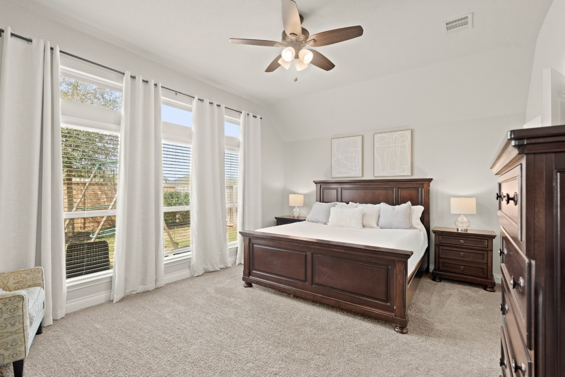 6918 Goldstrum Way Katy, TX 77493 - Photo 12 of 27 a spacious bedroom with a bed dresser and a window
