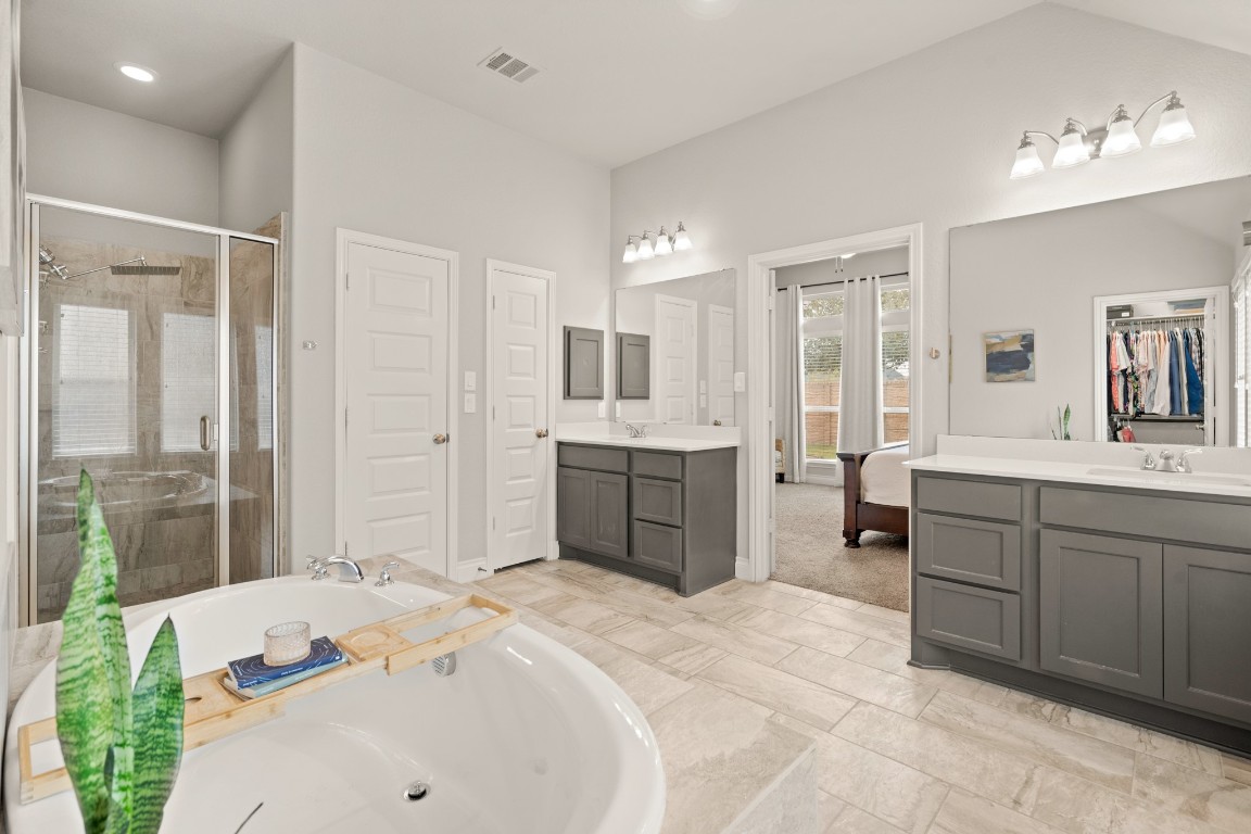 6918 Goldstrum Way Katy, TX 77493 - Photo 15 of 27 a spacious bathroom with a sink mirror and a bath tub