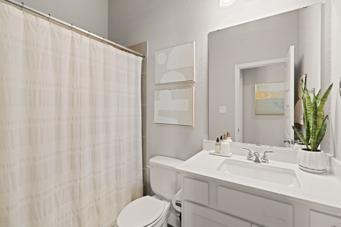 6918 Goldstrum Way Katy, TX 77493 - Photo 19 of 27 a bathroom with a sink and a mirror