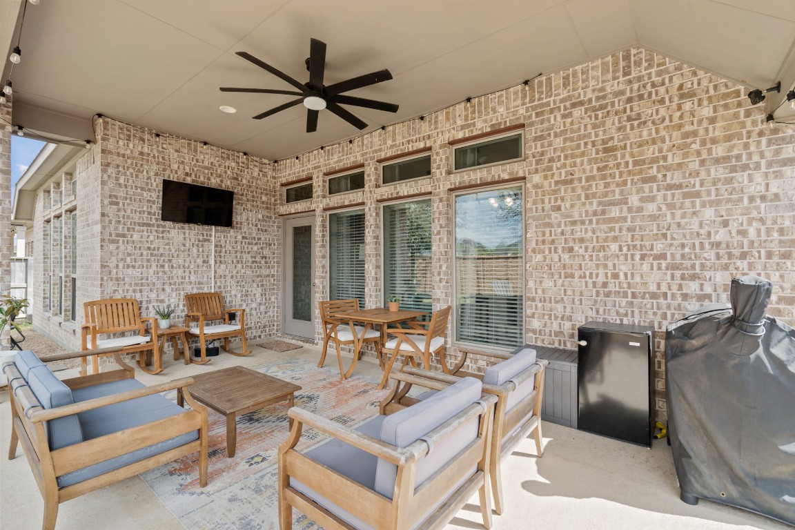 6918 Goldstrum Way Katy, TX 77493 - Photo 22 of 27 a living room with furniture a fireplace and a flat screen tv