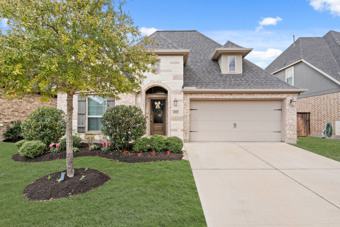 6918 Goldstrum Way Katy, TX 77493 - Photo 25 of 27 a front view of a house with a garden
