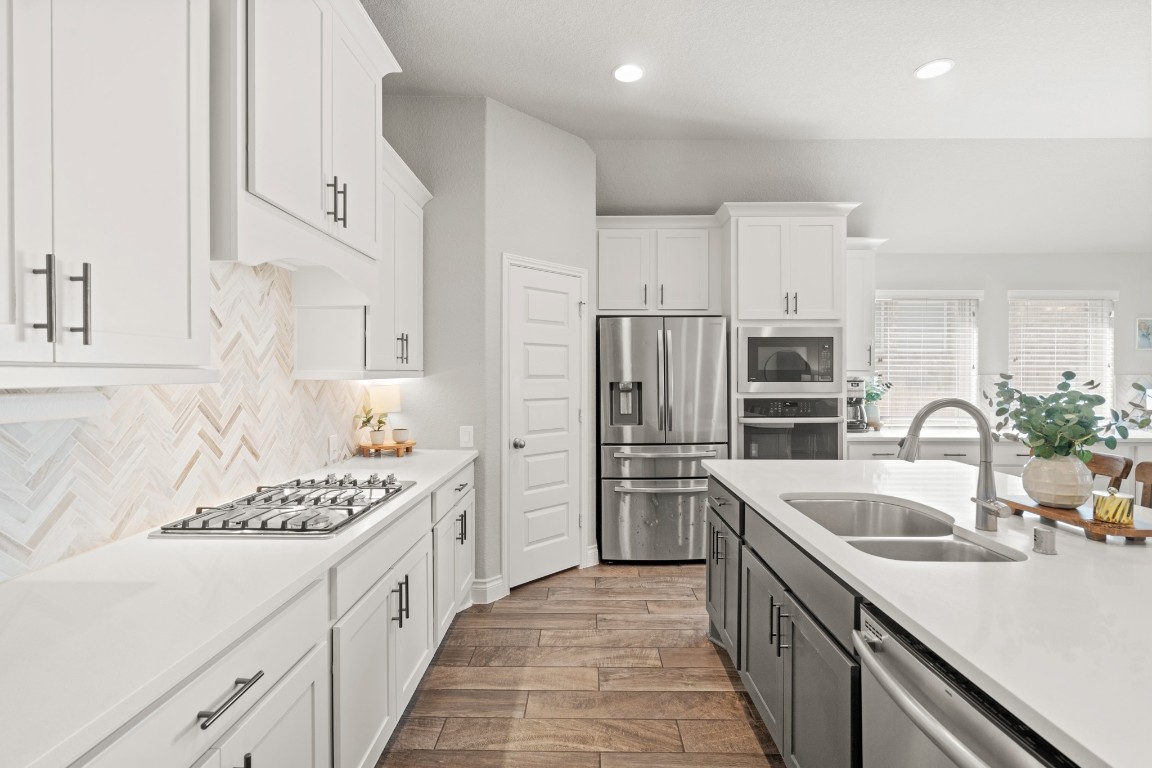 6918 Goldstrum Way Katy, TX 77493 - Photo 5 of 27 a kitchen with stainless steel appliances kitchen island granite countertop a sink stove and refrigerator