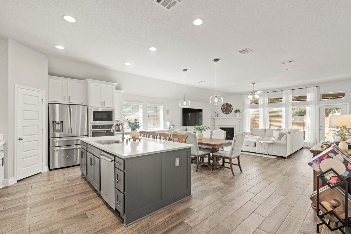 6918 Goldstrum Way Katy, TX 77493 - Photo 6 of 27 a kitchen with stainless steel appliances kitchen island granite countertop a sink and a refrigerator