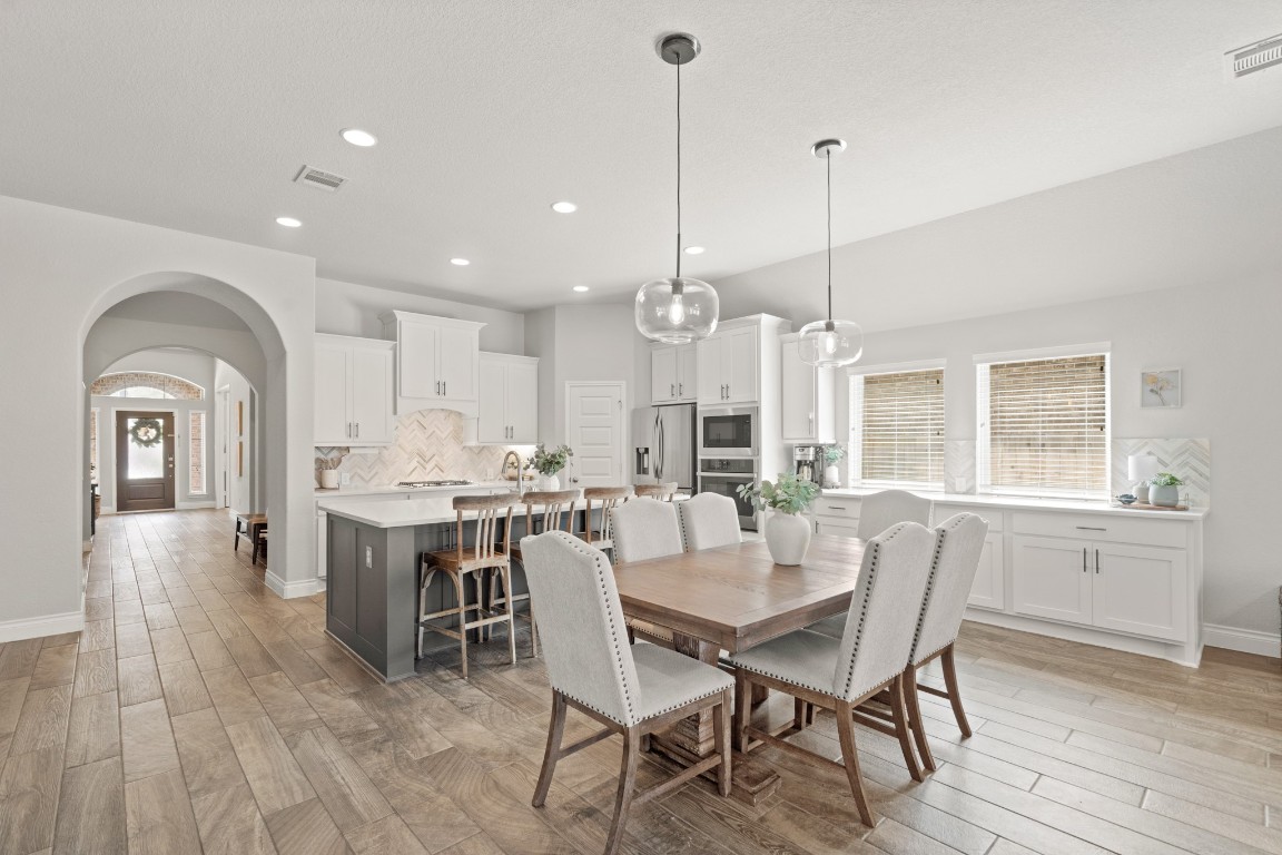 6918 Goldstrum Way Katy, TX 77493 - Photo 7 of 27 a view of a dining room with furniture window and wooden floor