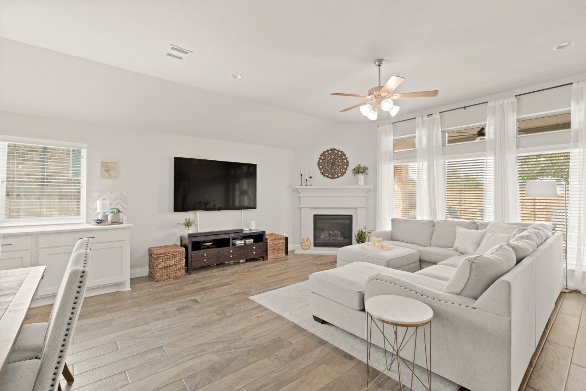 6918 Goldstrum Way Katy, TX 77493 - Photo 8 of 27 a living room with furniture a fireplace and a flat screen tv