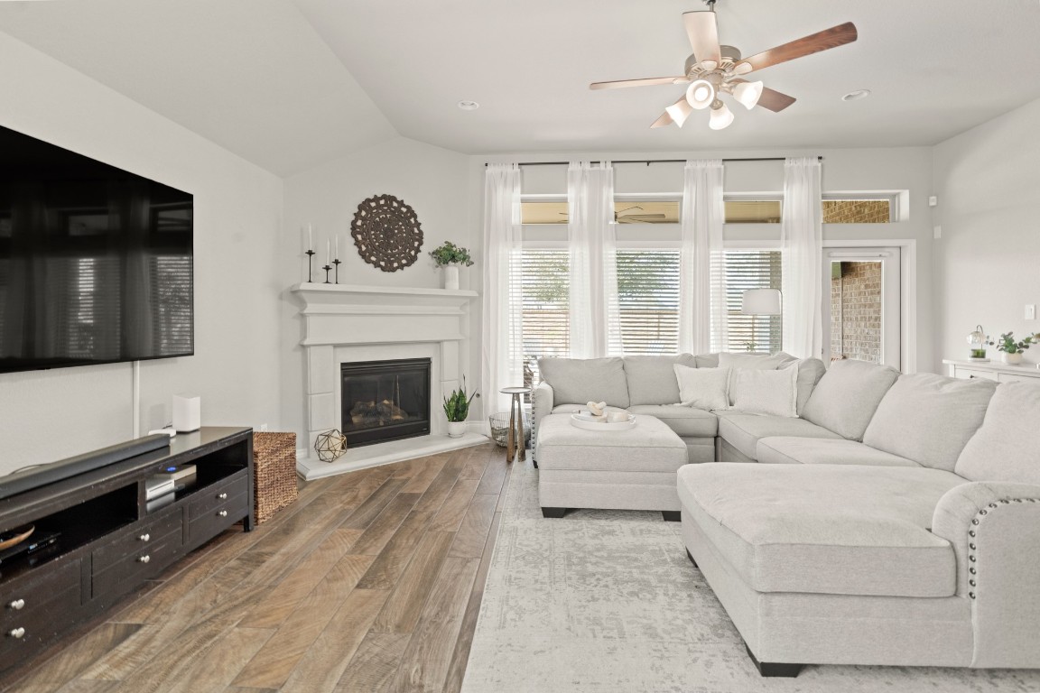 6918 Goldstrum Way Katy, TX 77493 - Photo 9 of 27 a living room with furniture a flat screen tv and a fireplace