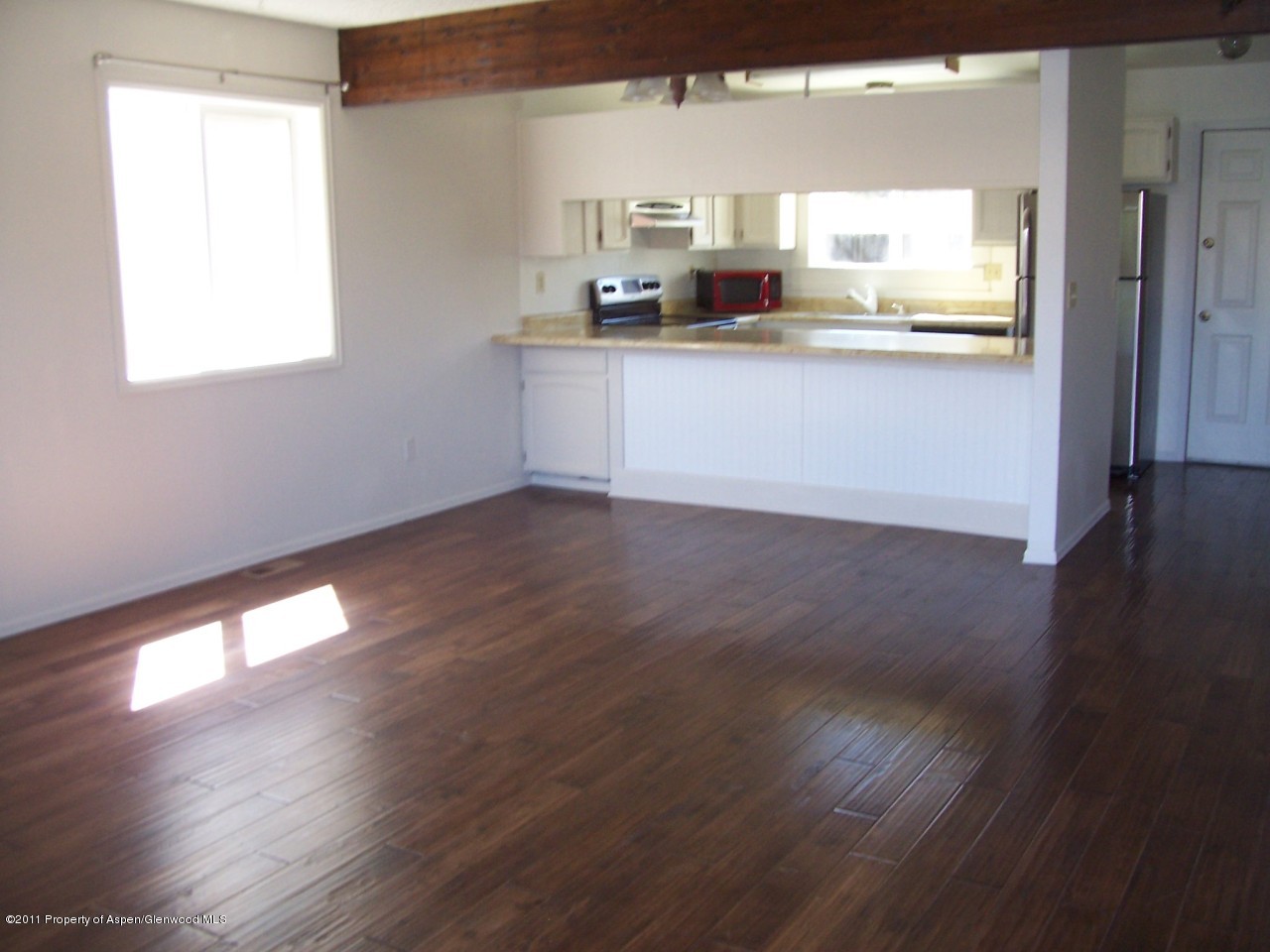 369 South 9th Street Rifle, CO 81650 - Photo 2 of 9 a kitchen with stainless steel appliances wooden floors and white walls