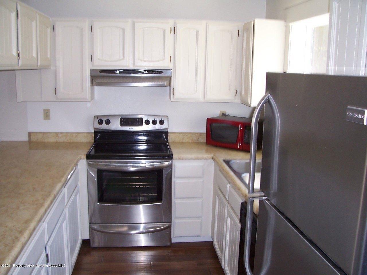 369 South 9th Street Rifle, CO 81650 - Photo 3 of 9 a kitchen with granite countertop a stove and a refrigerator