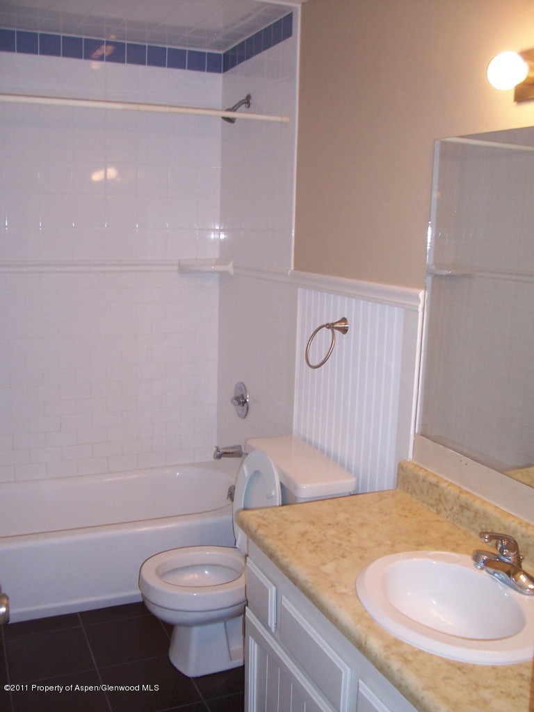 369 South 9th Street Rifle, CO 81650 - Photo 5 of 9 a bathroom with a sink a toilet and a bathtub