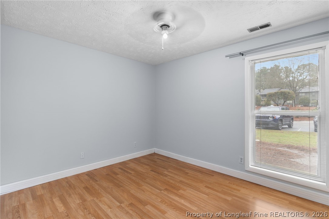 1908 Tryon Drive, Unit 1 Fayetteville, NC 28303 - Photo 21 of 29 a view of empty room with wooden floor and fan
