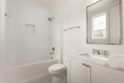 a bathroom with a sink toilet a vanity and bathtub