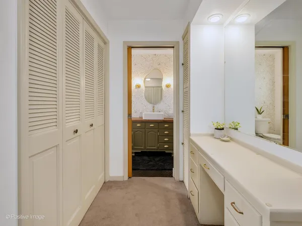 a bathroom with a sink a vanity and mirror