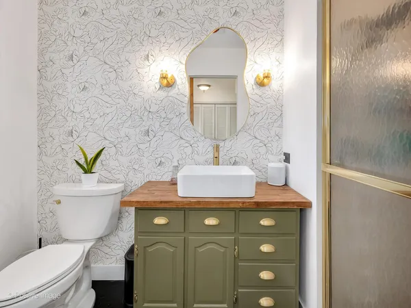 a bathroom with a sink a toilet and mirror