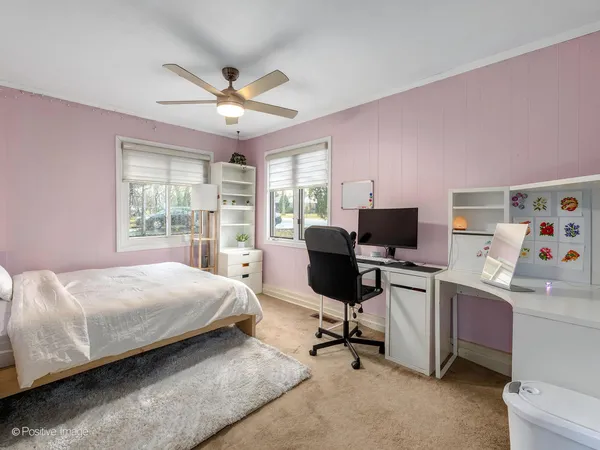 a bedroom with a workspace