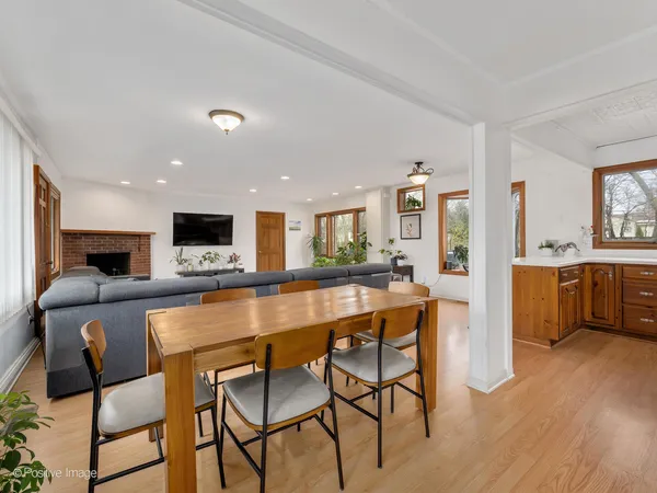 a large kitchen with a table and chairs