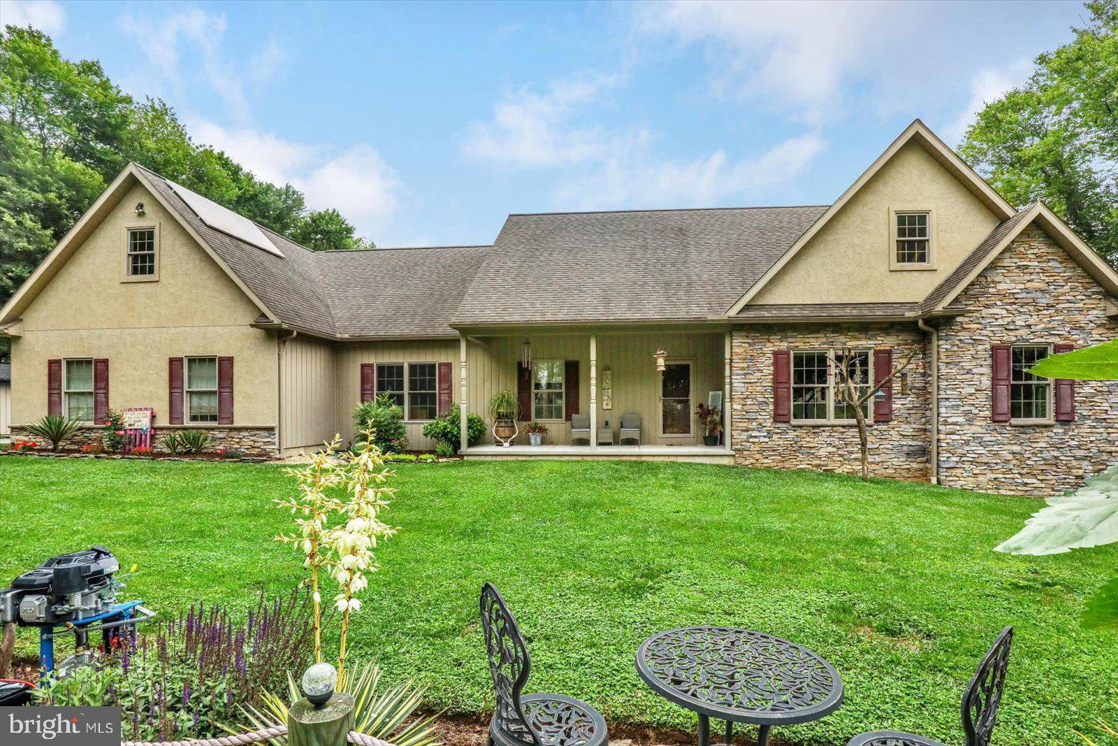 a front view of a house with a garden and patio