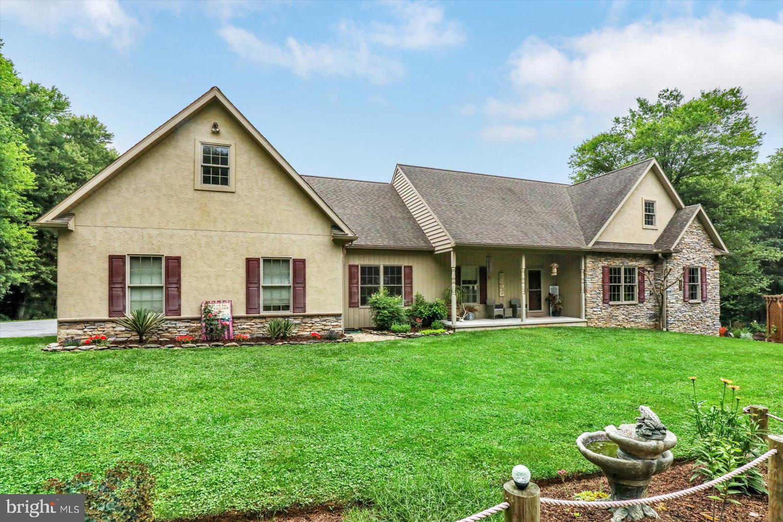 1881 Georgetown Road Christiana, PA 17509 - Photo 2 of 45 a front view of a house with a garden and trees