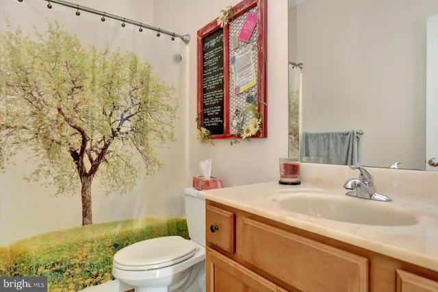 a kitchen with stainless steel appliances granite countertop a stove a sink dishwasher and a refrigerator with wooden floor