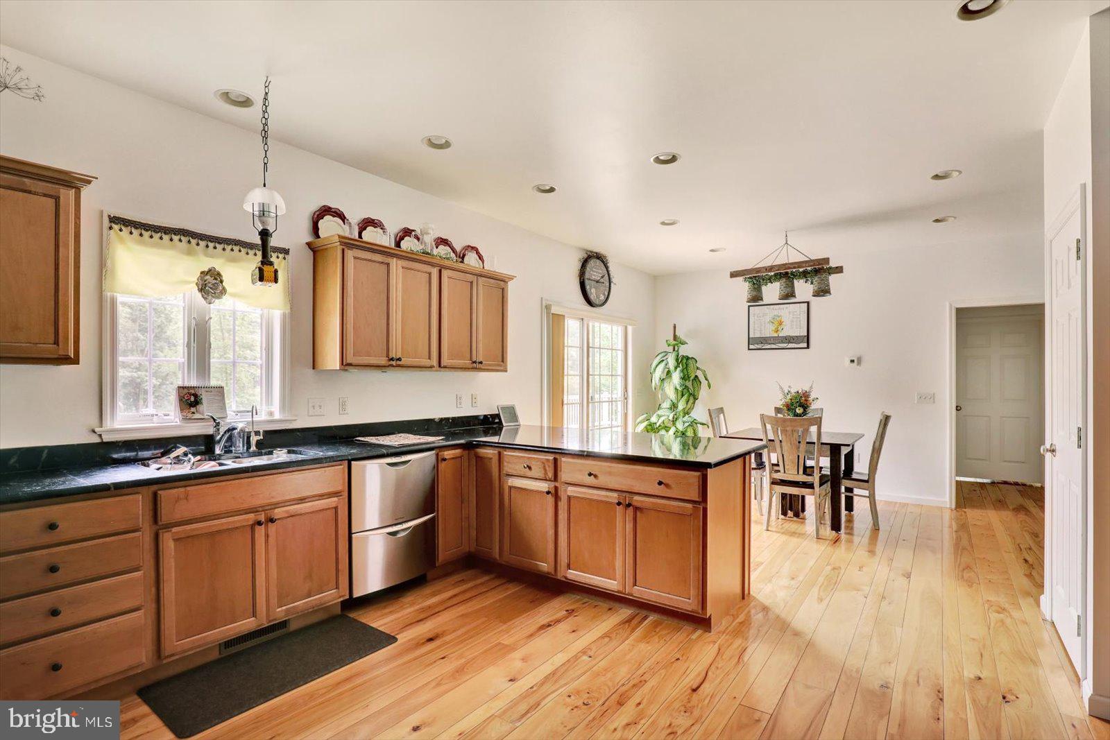1881 Georgetown Road Christiana, PA 17509 - Photo 25 of 45 a large kitchen with stainless steel appliances a table and chairs in it