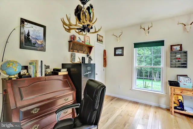 a bedroom with furniture and wooden floor